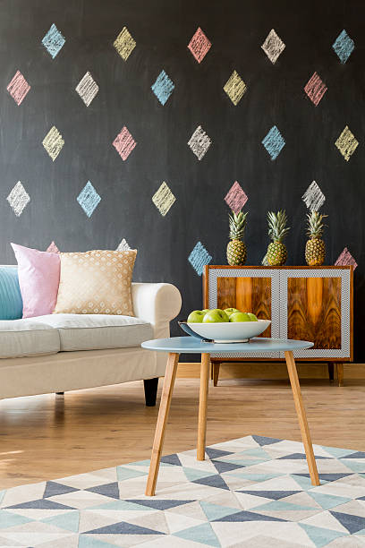 Couch with colourful pillows in the living room with black walls