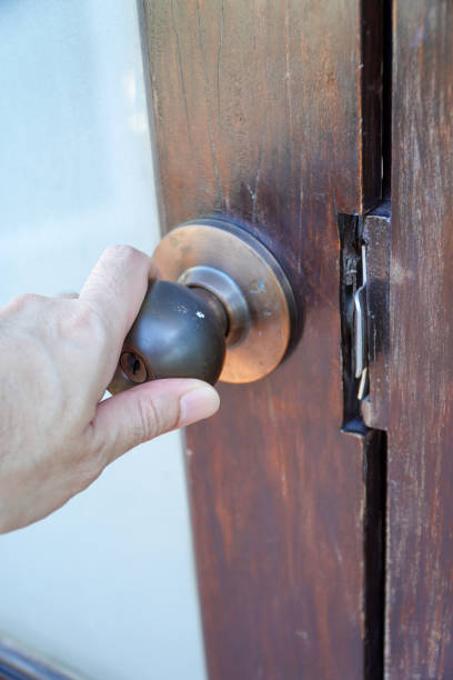 Man hand opens door knob,Hand open the door with a doorknob تركيب شواحن السيارات في أبوظبي