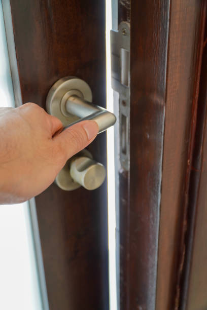man's hand opening the door with doorknob. Close up. تركيب شواحن السيارات في أبوظبي