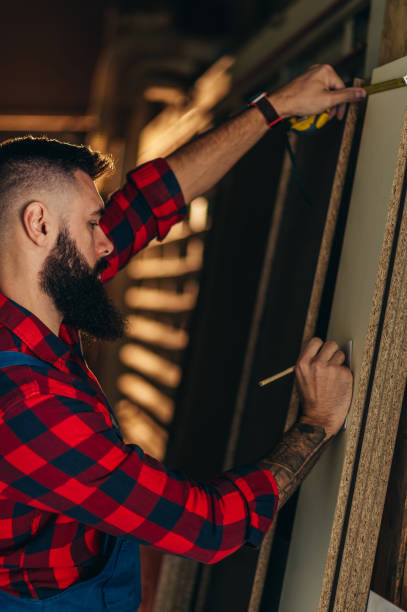 Young male carpenter working in workshop تركيب شواحن السيارات في أبوظبي